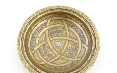 A Middle Eastern brass dish / bowl with incised detail and i...