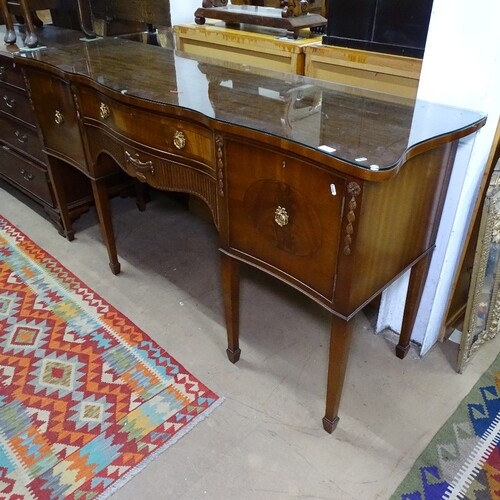 A Regency style mahogany serpentine-front sideboard, fitted ...