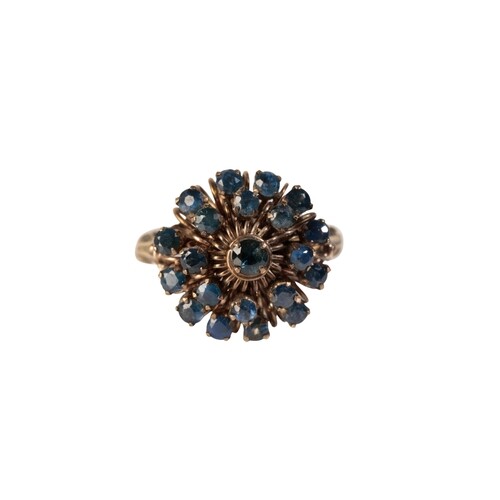 A SAPPHIRE CLUSTER RING, the raised cluster set on a yellow ...