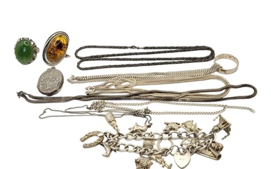 A VINTAGE SILVER CHARM BRACELET Set with numerous charms on...