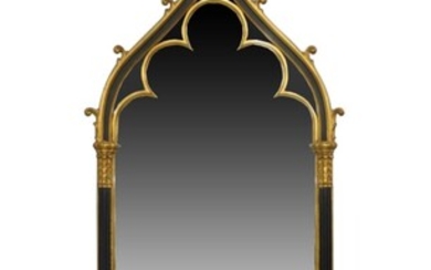 A Victorian Gothic revival style gilt and ebonized framed mirror, late 20th century, with fleur de lys pediment above reeded corinthian columns, stamped Carol Canner, 1994, for carvers guild, 169cm x 68cm Provenance: The Geoffrey and Fay Elliot...