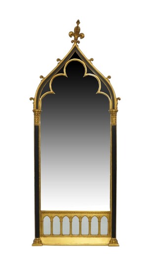 A Victorian Gothic revival style gilt and ebonized framed mirror, late 20th century, with fleur de lys pediment above reeded corinthian columns, stamped Carol Canner, 1994, for carvers guild, 169cm x 68cm Provenance: The Geoffrey and Fay Elliot...