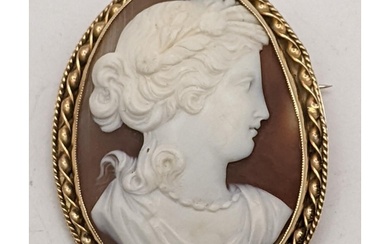 A Victorian yellow metal cameo brooch depicting a maiden wit...