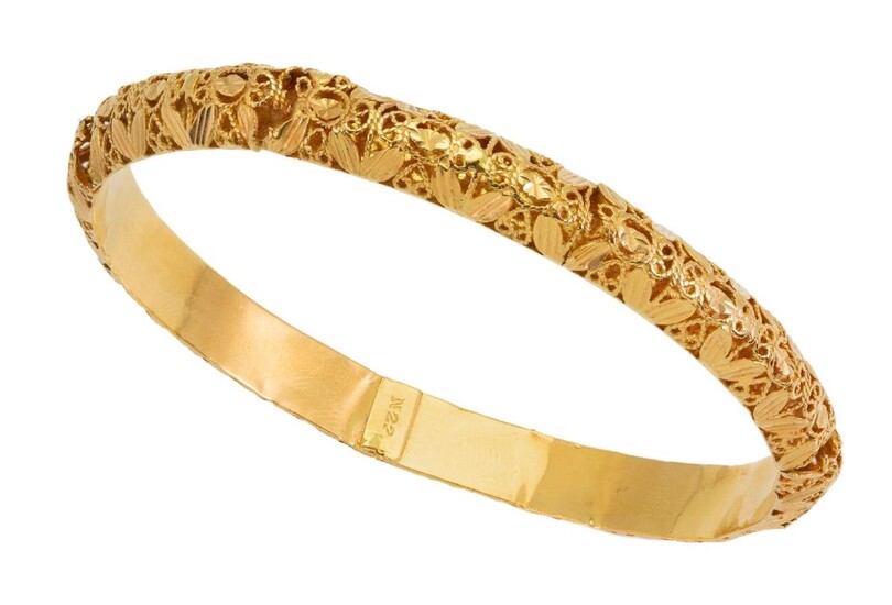 A bangle, of open work filigree design, inner circumference approximately 21cm, gross weight approximately 23g