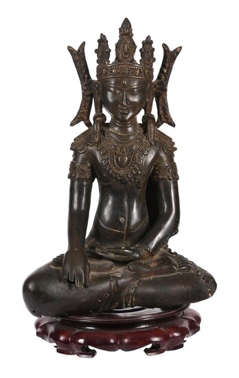 A bronze figure of the crowned Buddha