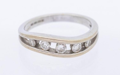 A diamond and 18ct white gold half eternity ring, comprising...
