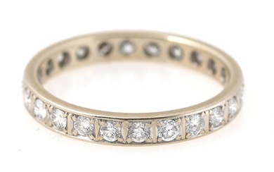 A diamond eternity ring set with numerous brilliant-cut diamonds, mounted in 14k...