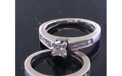 A diamond solitaire ring set with diamond shoulders and a di...
