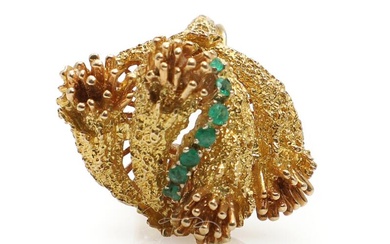 A emerald ring set with seven faceted emeralds, mounted in 18k gold....
