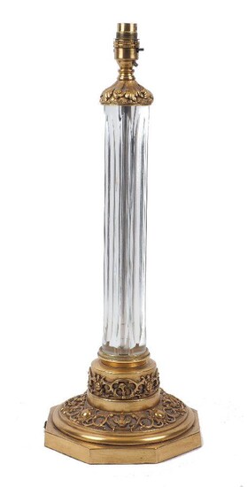 A glass and brass table lamp, 20th century, of cylindrical form, with cast design to top and bottom rims, 53cm high