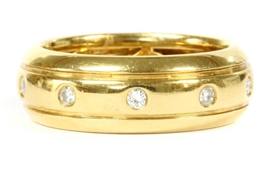A gold diamond set band ring