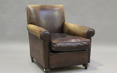 A late 20th century brown leather club armchair, on bun feet and castors, height 86cm, width 85cm, d