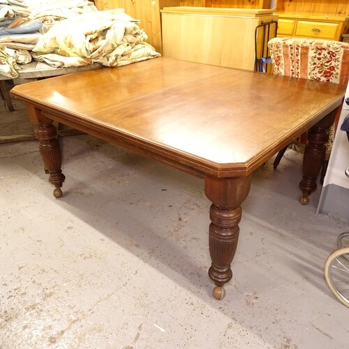 A late Victorian walnut canted-cornered wind-out dining tabl...