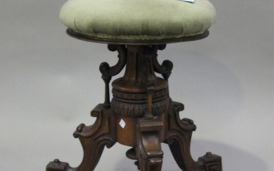 A late Victorian walnut revolving piano stool, raised on carved tripod legs, height 49cm, diameter 3