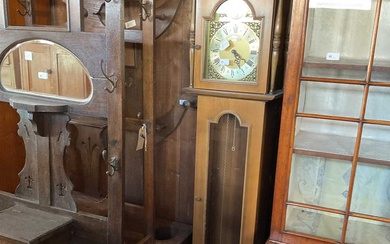 A modern oak effect longcase clock, the brass face set...