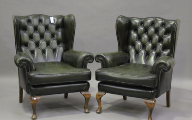 A pair of 20th century George III style wingback armchairs, upholstered in buttoned green leather, o