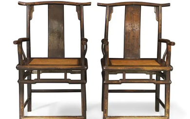 A pair of Chinese provincial lacquered elm yoke back armchairs, Qing dynasty,...