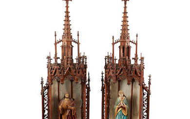 A pair of Gothic style polychrome decorated figures of the Virgin and Christ within carved niches