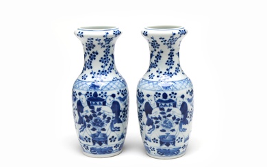 A pair of blue and white porcelain vases each painted with children holding vase alternating with birds on plum branches
