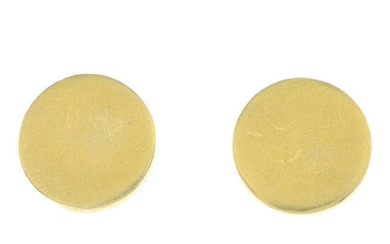 A pair of circular stud earrings.