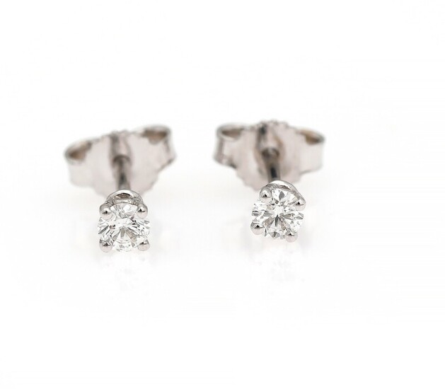 SOLD. A pair of diamond ear studs each set with a brilliant-cut diamond, mounted in...