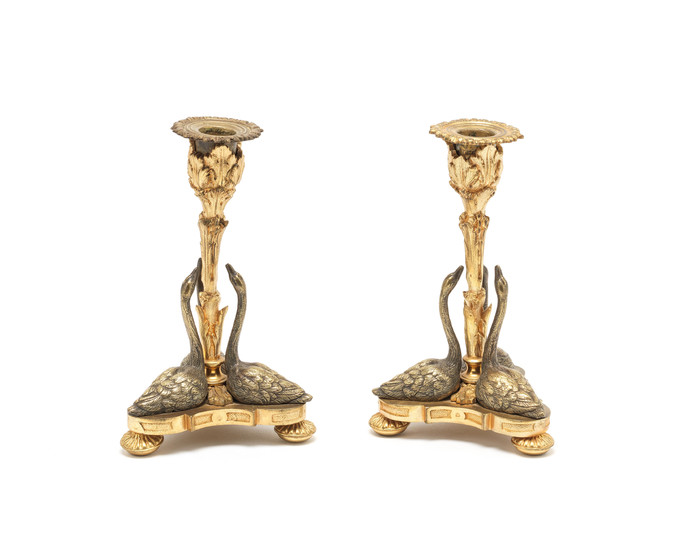 A pair of early Victorian silvered and parcel gilt swan candlesticks