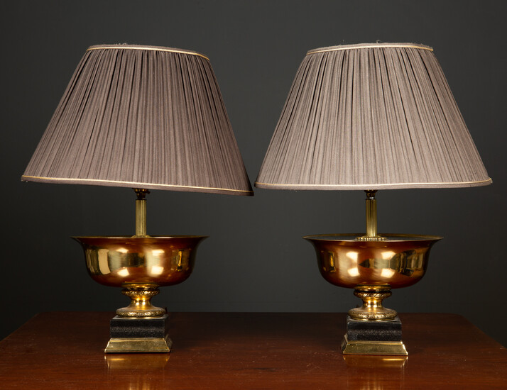 A pair of gilt metal and ebonised table lamps