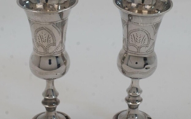 A pair of silver Kiddush wine cups, London, 1920, J Zeving (or Joseph Zweig), of baluster form on knopped stems and circular bases, with engraved decoration, 12.5cm high, total weight approx. 2.8oz (2)