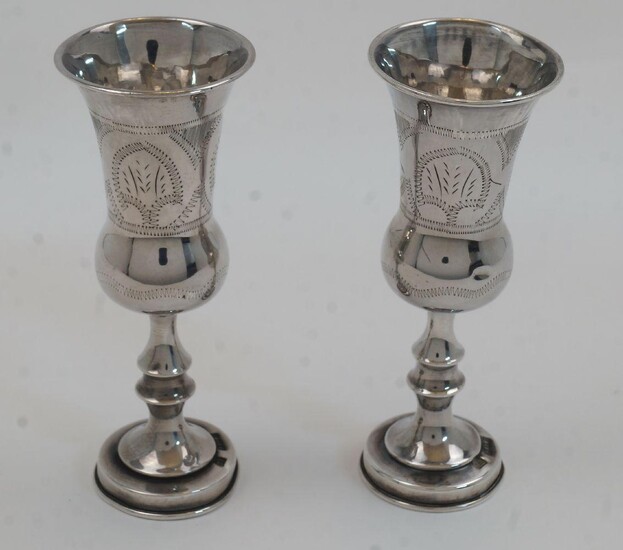 A pair of silver Kiddush wine cups, London, 1920, J Zeving (or Joseph Zweig), of baluster form on knopped stems and circular bases, with engraved decoration, 12.5cm high, total weight approx. 2.8oz (2)