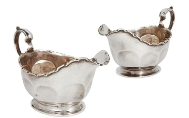 A pair of silver Mappin & Webb sauce boats, Birmingham, 1928, designed with shaped rims and scroll handles, 15cm long, 8.6cm high (inc. handles), total weight approx. 9oz (2)