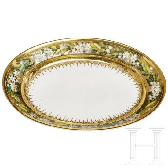 A porcelain bowl with a broad gold rim and flowers