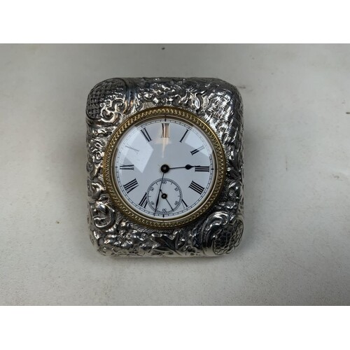 A sterling silver travel clock with repousse decoration in o...