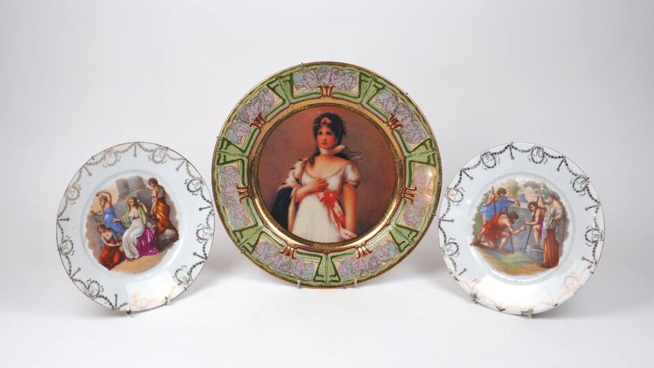 A transfer printed Vienna-style porcelain cabinet plate, 20th century, decorated with a lady, 35cm diameter; together with two Vienna-style porcelain cabinet plates, each decorated with Classical figures, 25cm diameter (3)