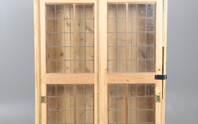 AN EARLY 20TH CENTURY STRIPPED PINE TWO-DOOR CUPBOARD.