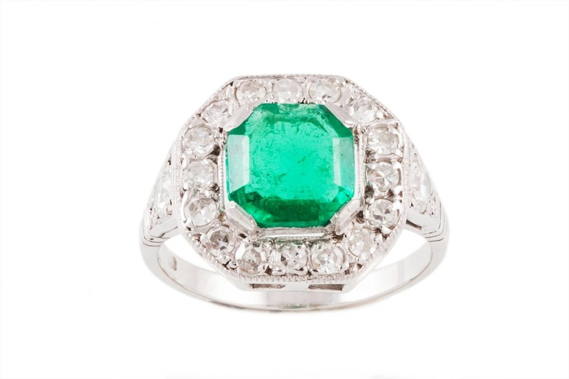 AN EMERALD AND DIAMOND CLUSTER RING, one octagonal step cut ...