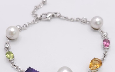 An 18 K white gold chain bracelet with a variety of gemstone...