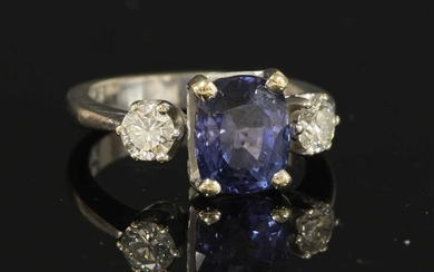 An 18ct white gold three stone sapphire and diamond ring