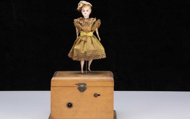 An 19th century clockwork dancing girl on musical box