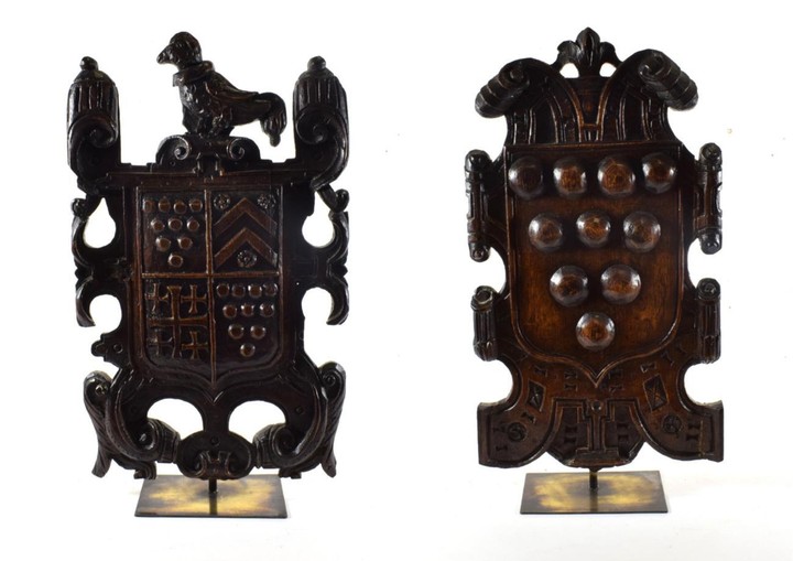 An Oak Armorial Plaque, 18th century, carved with a bird...