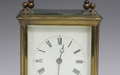 An early 20th century lacquered brass corniche cased carriage clock with eight day movement striking