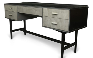 An ebonised desk, upcycled by Ruby Rhino, the rectangular top above an arrangement of five grey painted drawers on on tapered supports, 70cm high, 152cm wide, 46cm deep