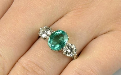 An emerald and brilliant-cut diamond three-stone ring.