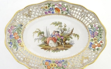 An oval basket dish with a reticulated floral border