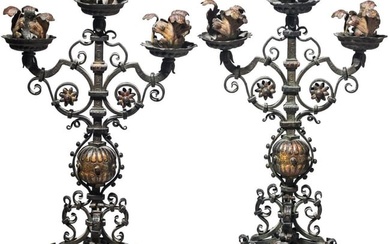 An unusual pair of three-armed iron candelabras, 17th century