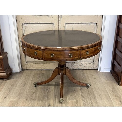 Antique Regency revival drum table, fitted with four drawers...