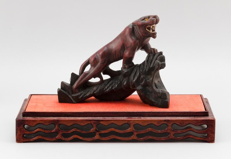 CARVED WOOD FIGURE OF A TIGER With glass eyes. On wood stand. Tiger length 8.25". Total length 14.5".