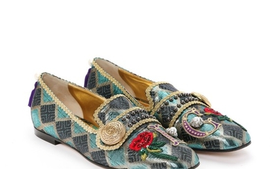 Dolce & Gabbana: A pair of loafers made of blue, gold and black glittery fabric, gold rims, gold buckle and embroidered details. Size 41.