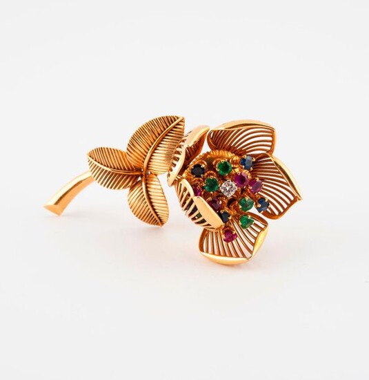 Flower lapel clip in yellow gold (750), the mobile pistils adorned with rubies, sapphires, emeralds and brilliant-cut diamonds in claw-set.