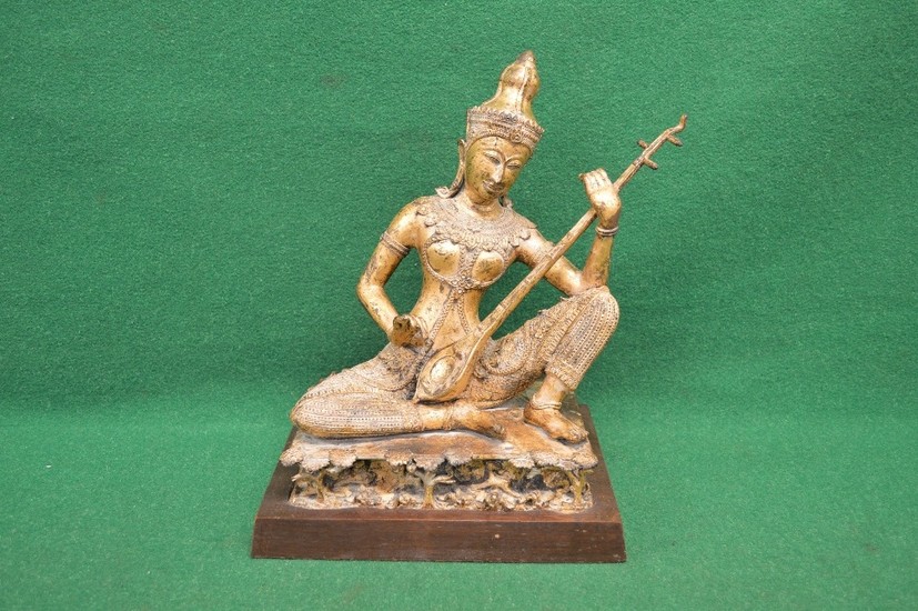 Gilded bronze figure of possibly Tibetan lady playing a musi...