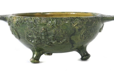 Handle probably around 1600, Germany, pottery, beige faience shards, green glazed, inside yellowish glazed, surrounding relief decor with winged putti and vegetable ornamental motifs, round form on three short feet, hxd: approx. 8.7/17.9 cm. Craquelée...